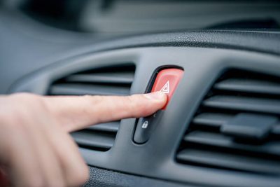 Use Hazard Lights Along With a Piece of the Flag at the Driver Side Window